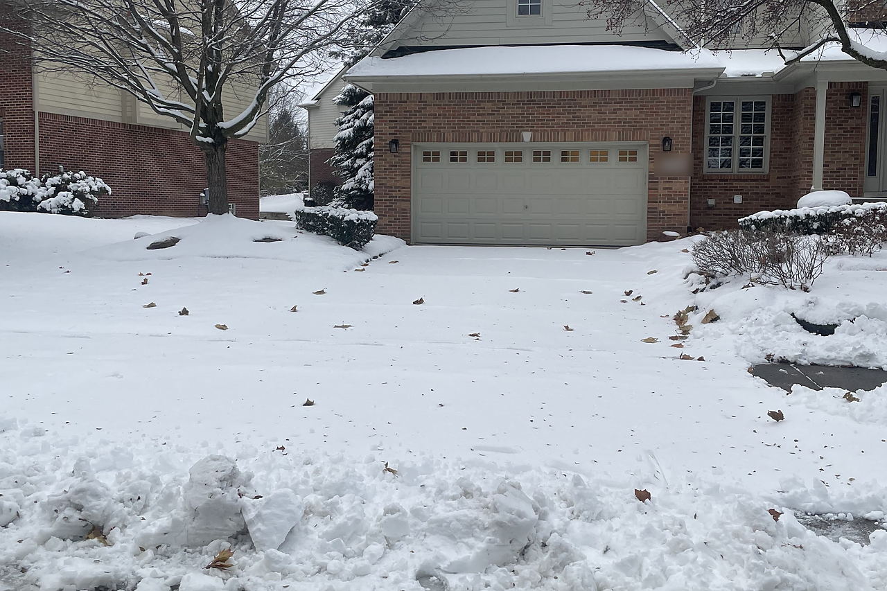 Driveway buried under snow before clearing